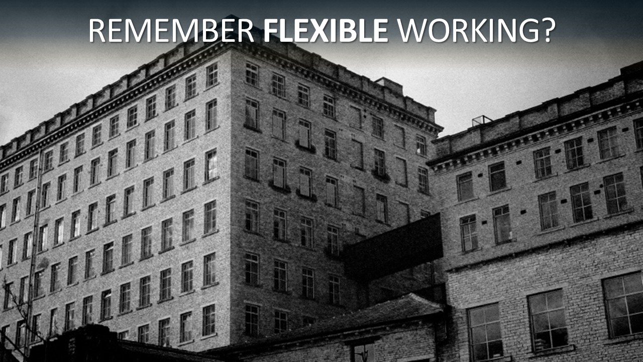 Black-and-white photograph of a vast, multi-storey Victorian brick mill, its facade a rigid grid of identical windows under a dark, brooding sky. Headline text across the top reads “Remember flexible working?” with the word “flexible” in bold, set against the factory’s unyielding rows.