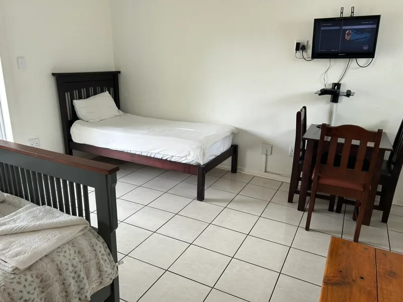 Single bed and table in Room 7