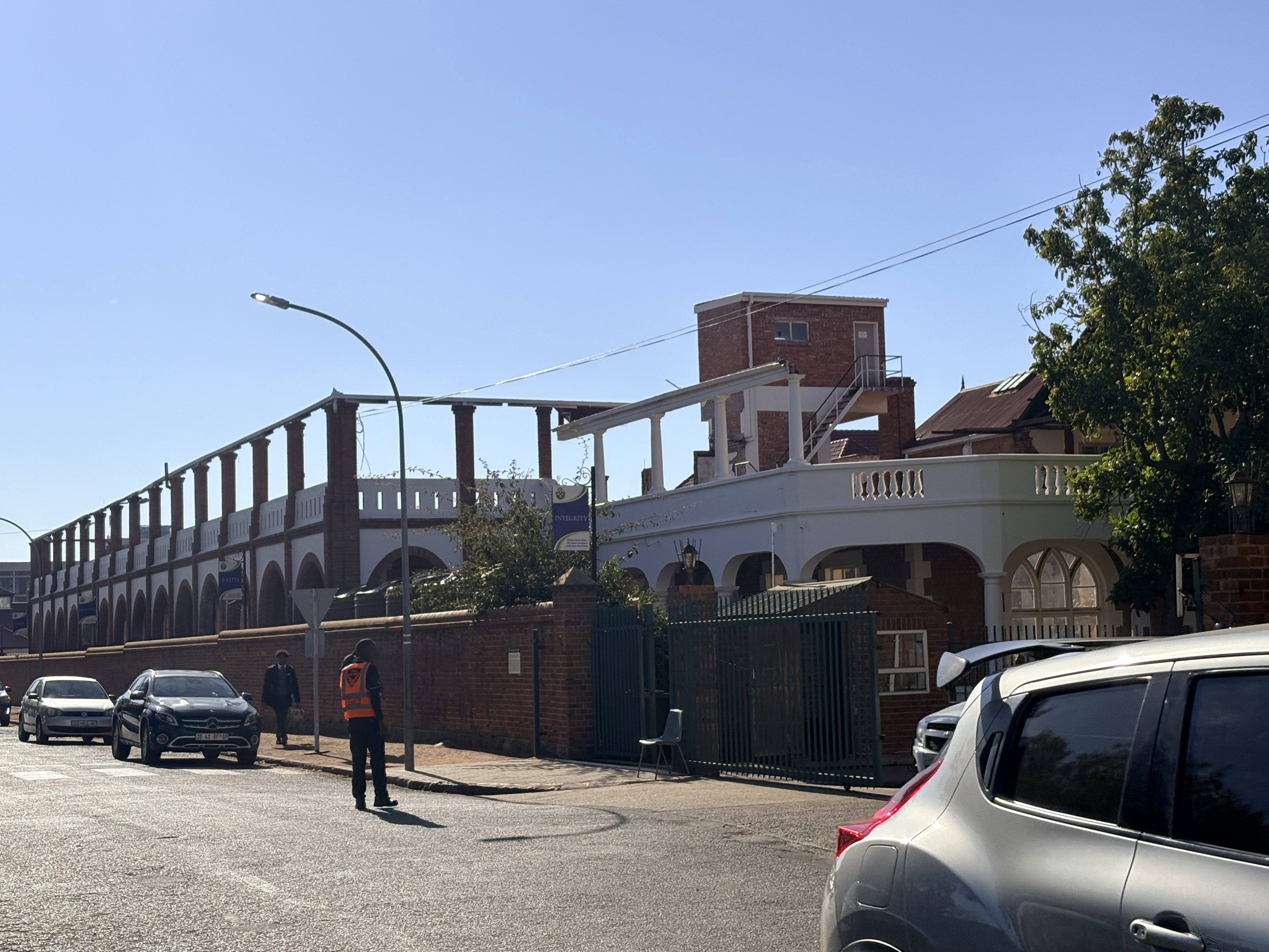 Fire-damaged Oppenheimer House, formerly Nazareth House, showing its surviving brick walls, arches and long collonaded structure.