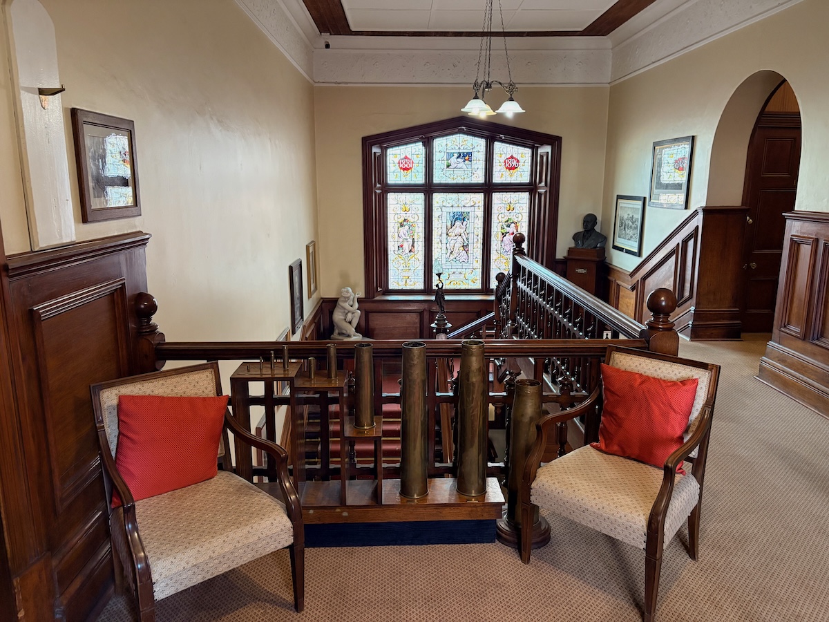 The magnificent double bend in the timber staircase, viewed from the upper floor.