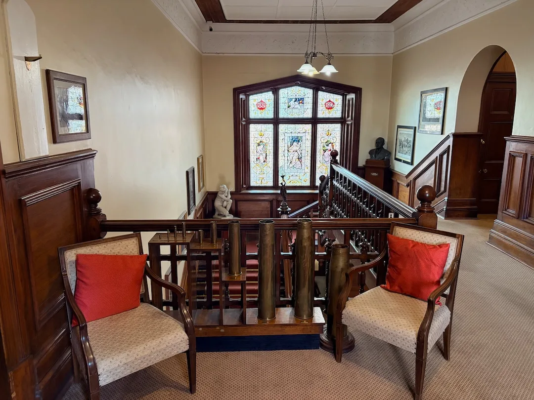 The magnificent double bend in the timber staircase, viewed from the upper floor.