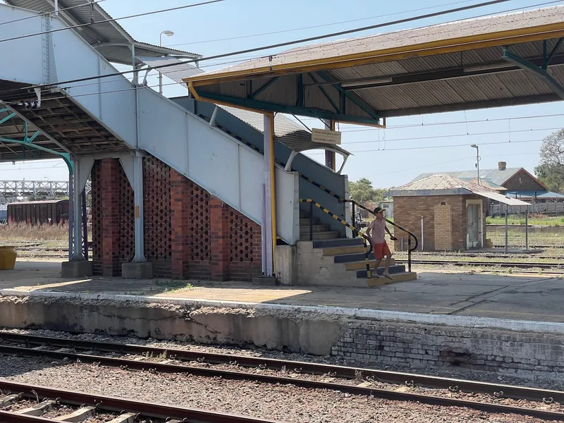 Historic covered footbridge crossing the railway lines at Kimberley Railway Station. 