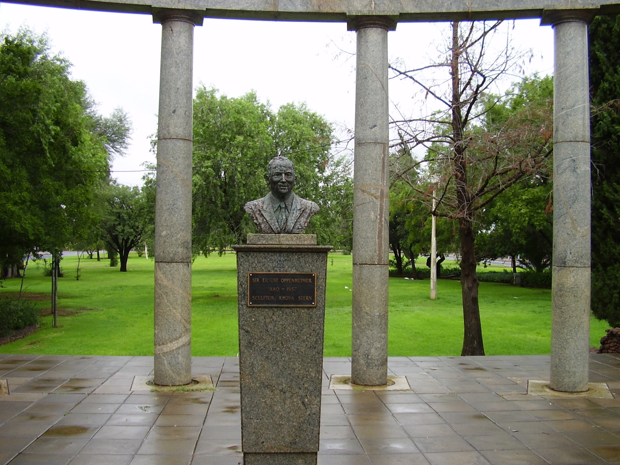 Bronze bust of Sir Ernest Oppenheimer framed by the curved marble colonnade in the Ernest Oppenheimer Memorial Gardens.
