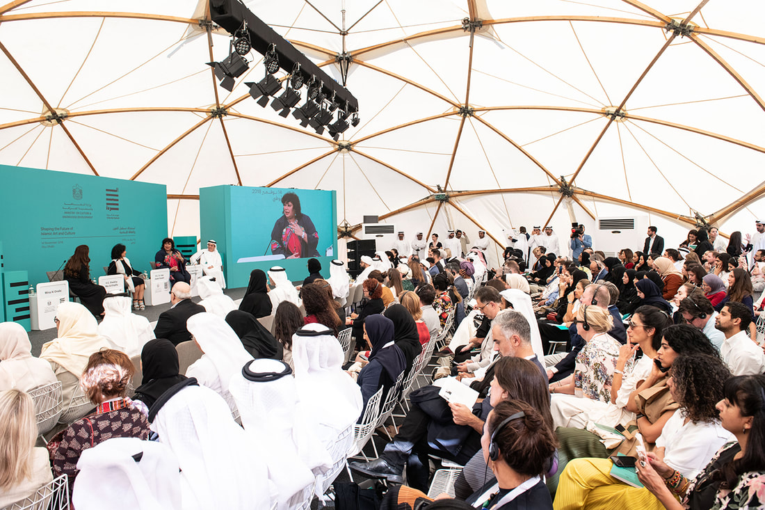 Conference panel and audience inside a temporary event structure