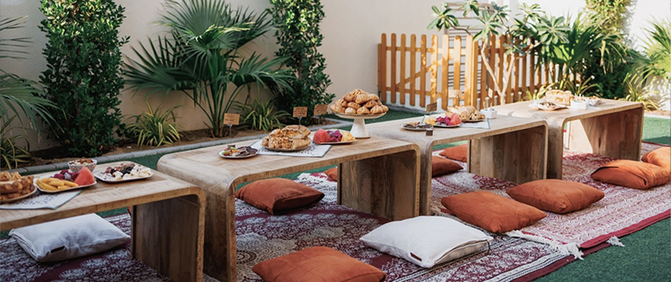 Intimate outdoor hospitality setting with traditional low seating and refreshments