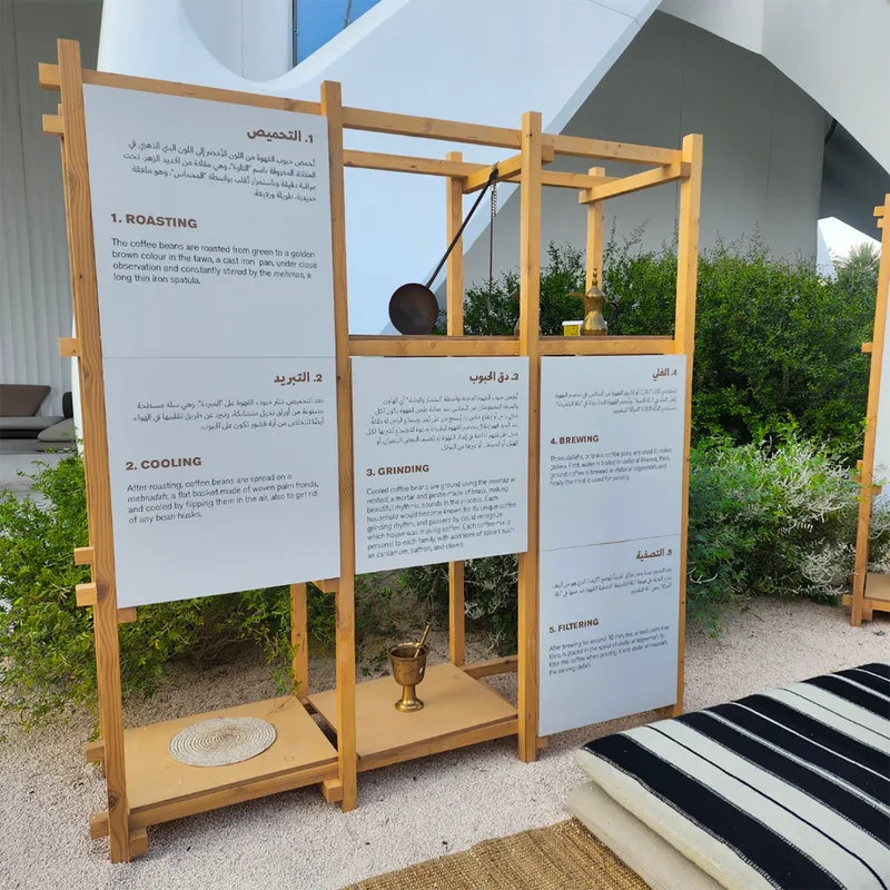 Timber shelving and interpretive panels forming the UAE Pavilion cultural scenic environment.