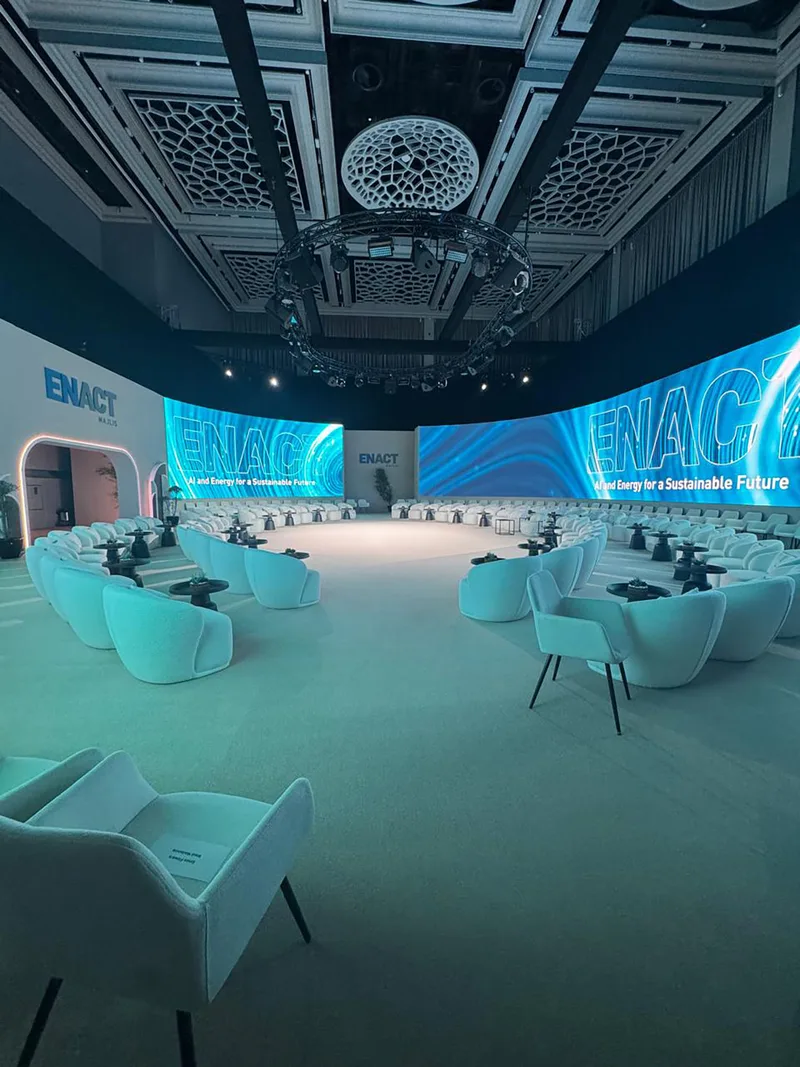 ADNOC ENACT Majlis plenary featuring coordinated curved screens and five-metre scenic walls.