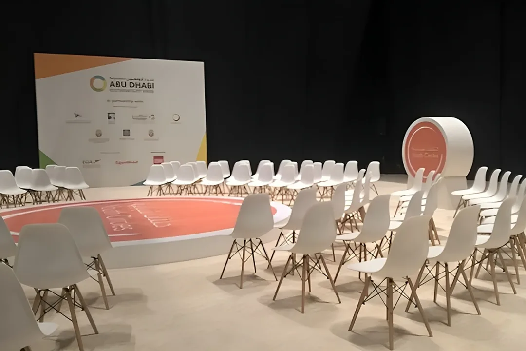 Evolution Scenic circular Youth Circle stage with orange branded floor graphic in Abu Dhabi.
