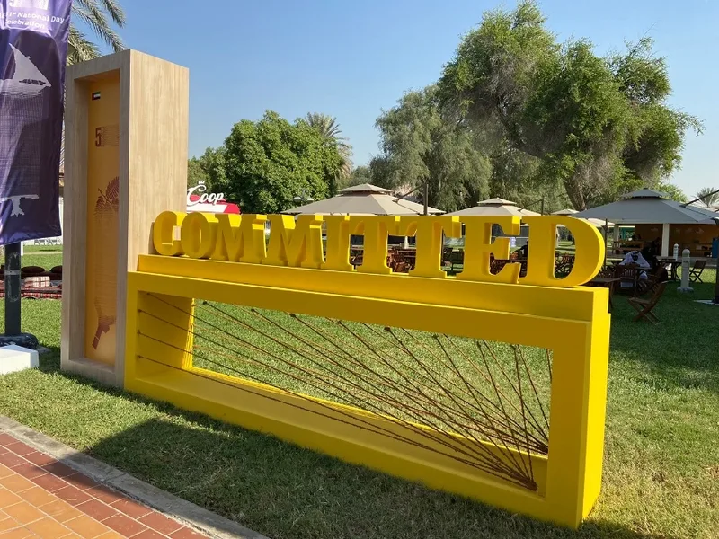 Branded scenic bench positioned beside freestanding display structures in the National Day environment.