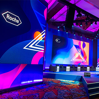 Evolution Scenic camera-ready broadcast set with integrated screens, lighting and concealed technical infrastructure.