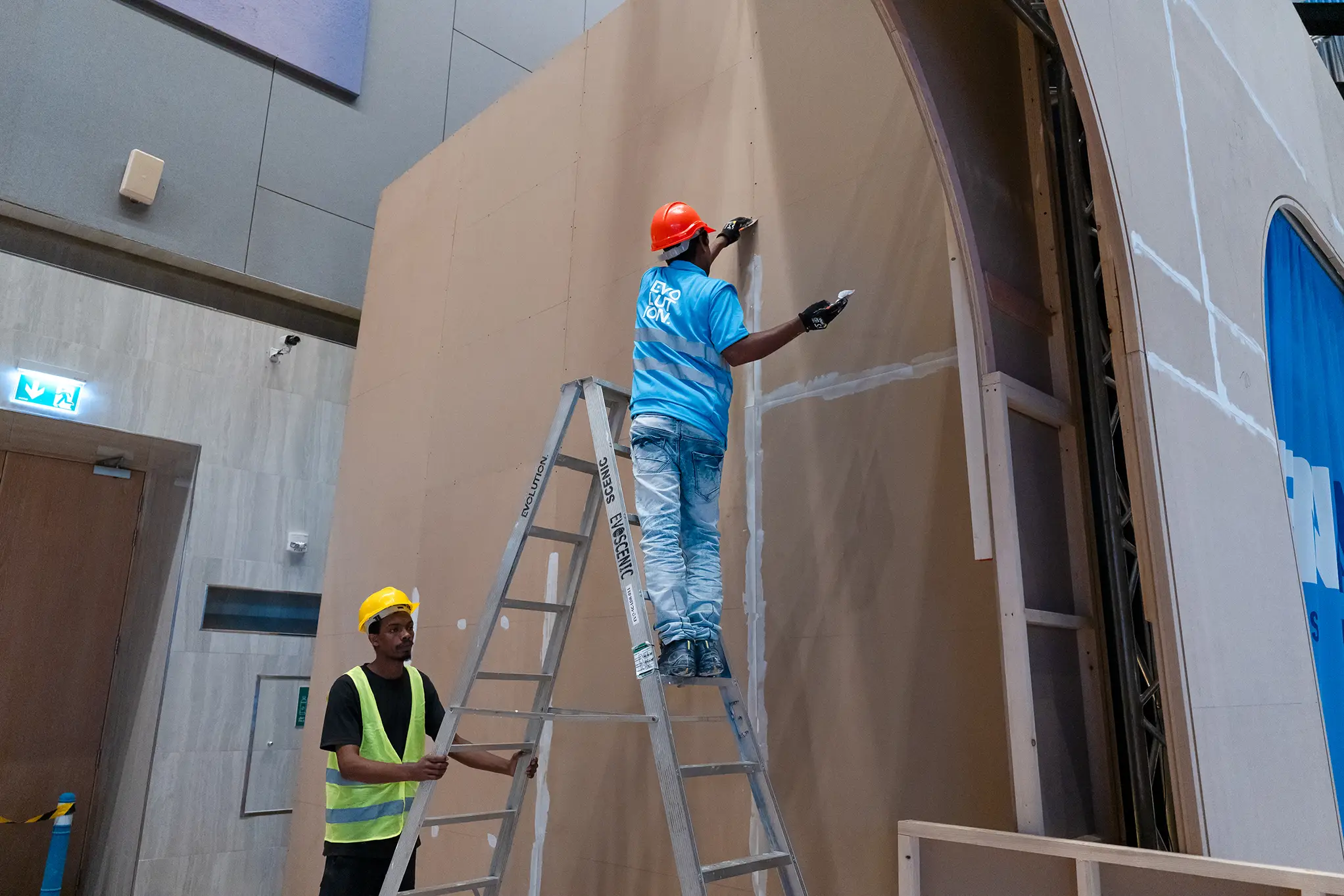 Serviceable technical component accessible behind a removable bespoke scenic panel
