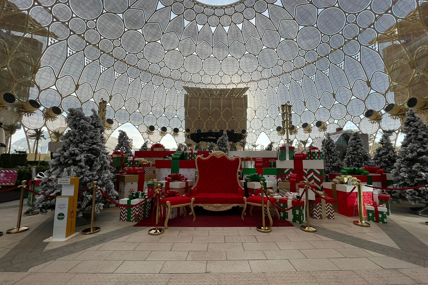 Snow-dressed scenic trees and gift-box structures installed throughout the Expo Christmas environment.