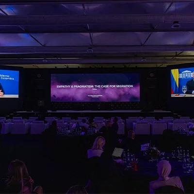 Evolution Scenic conference stage with black scenic walls and integrated venue LED screen.
