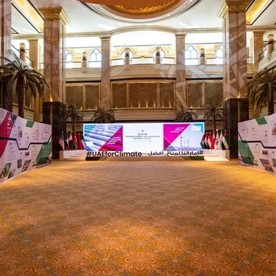 Evolution Scenic angled graphic walls framing the UAE Regional Climate Dialogue stage at Emirates Palace.