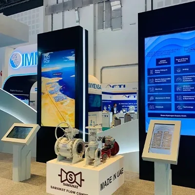 ADNOC exhibition stand featuring painted MDF scenic structures and large integrated digital display screens