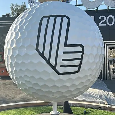 Two-metre fibreglass golf-ball sculpture mounted within the custom circular scenic platform.