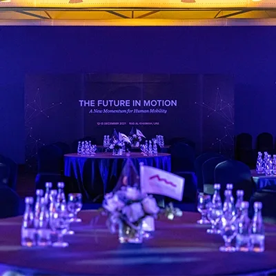 Evolution Scenic conference stage with black scenic walls and integrated venue LED screen.