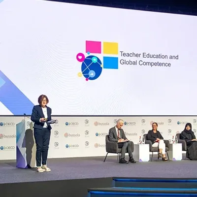 Modular stage deck with framed LED screen integration for the Qudwa–PISA Forum.