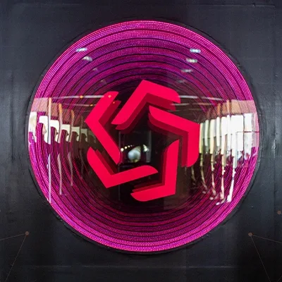 Evolution Scenic circular illuminated entrance feature within the branded exhibition environment.