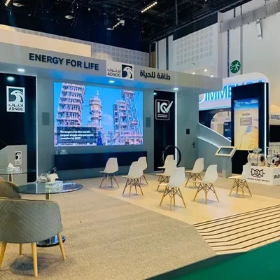 Custom fabricated white scenic walls and presentation area forming the ADNOC ADIPEC exhibition environmen