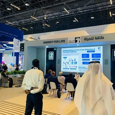 Painted MDF scenic walls carrying ADNOC Energy for Life branding within the Abu Dhabi exhibition stand
