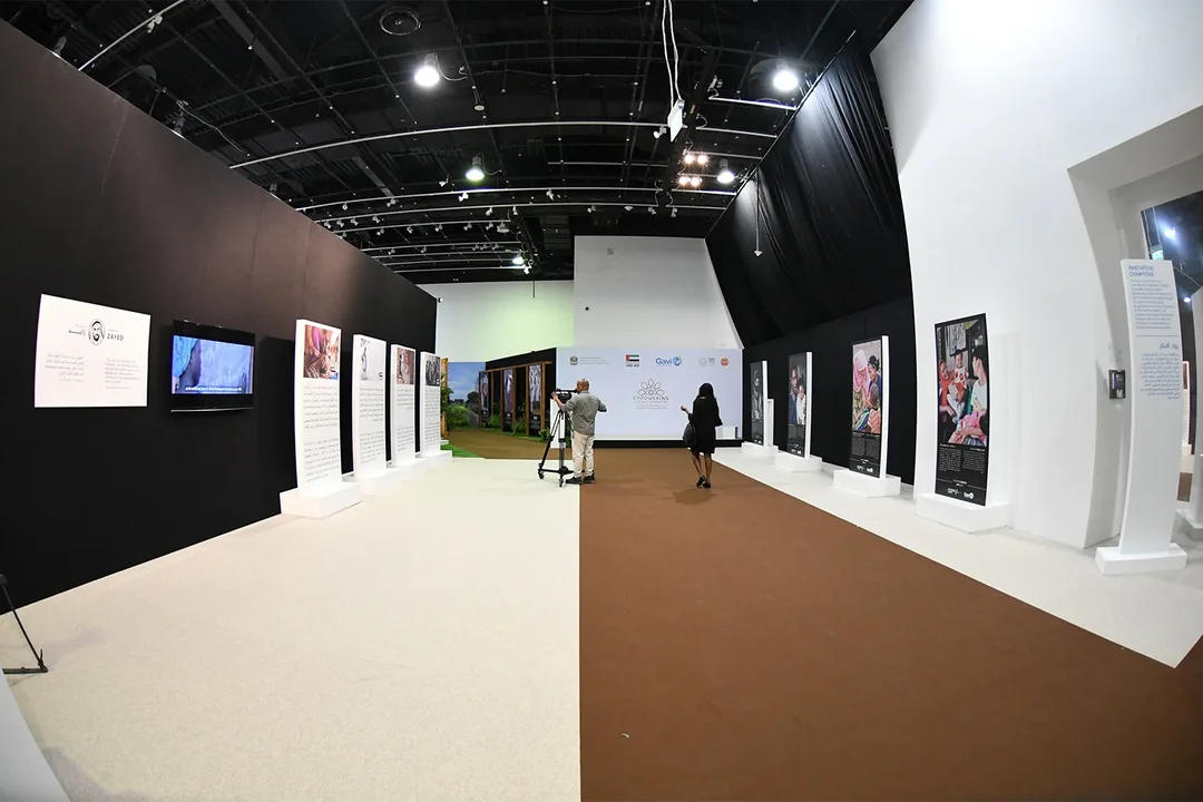 Black drape partitions transforming an exhibition hall into controlled temporary spaces
