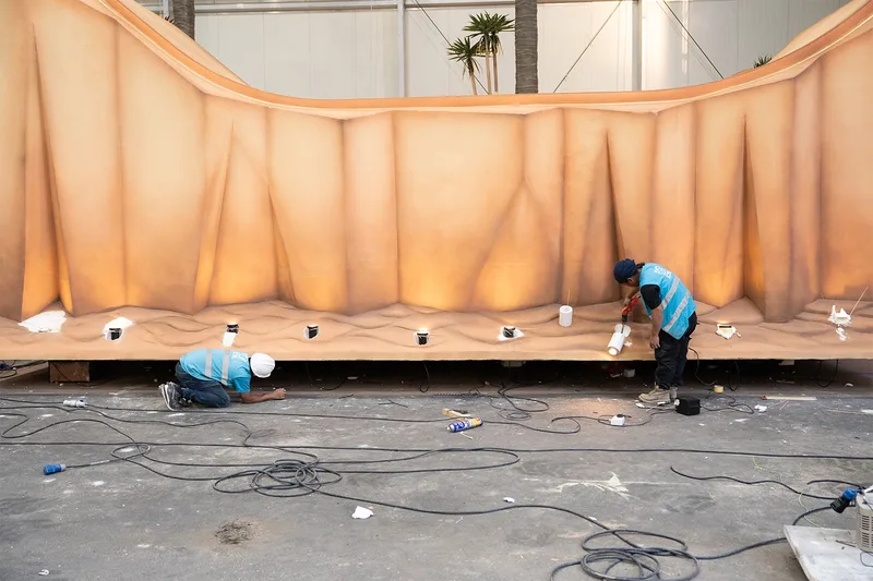 Lightweight scenic surface engineered to create the appearance of a solid heavy form