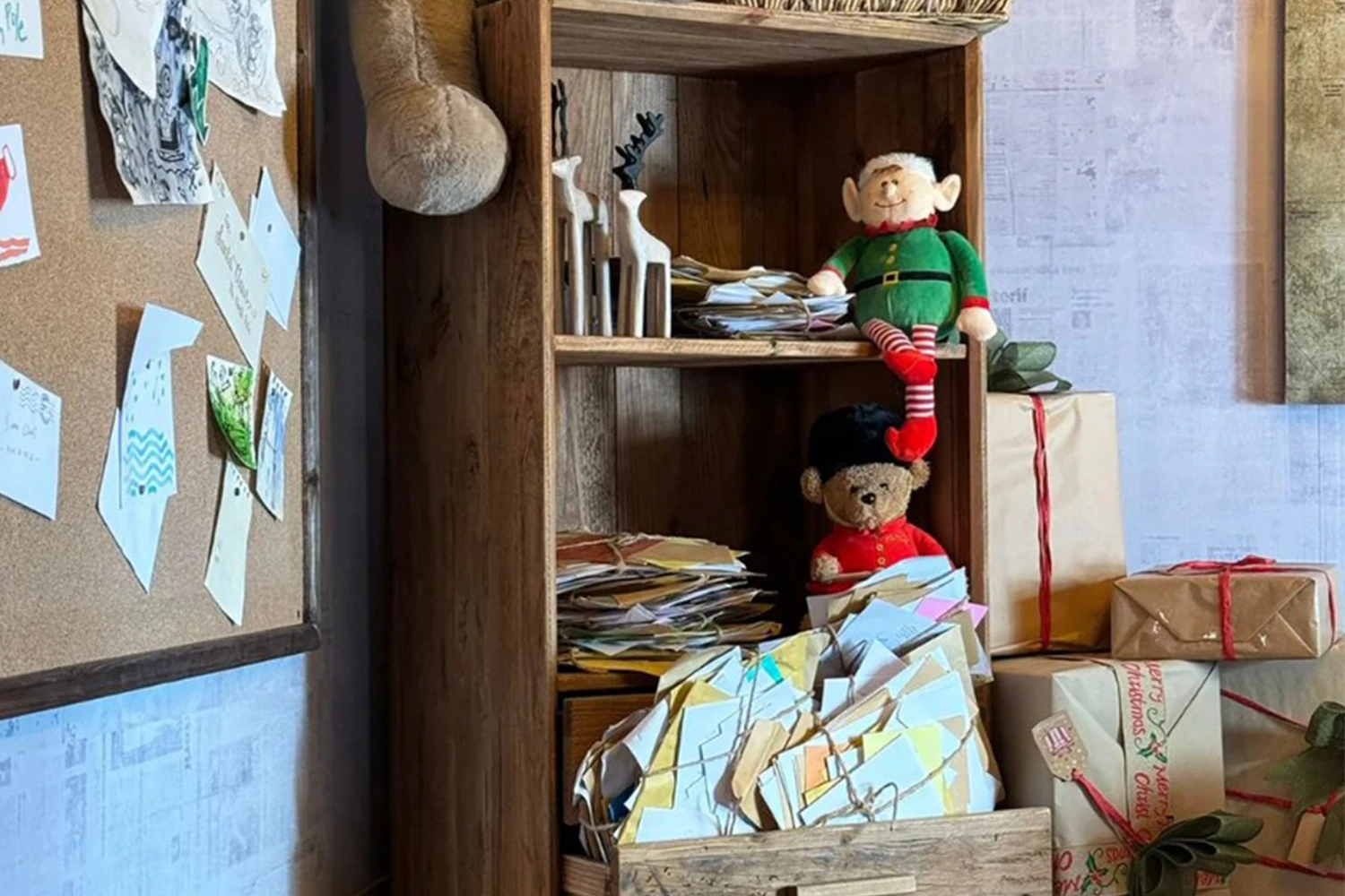 OSB-style interior panels, exposed beams and fitted storage inside Santa’s workshop.