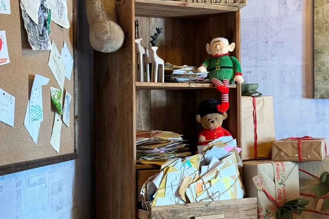 OSB-style interior panels, exposed beams and fitted storage inside Santa’s workshop.