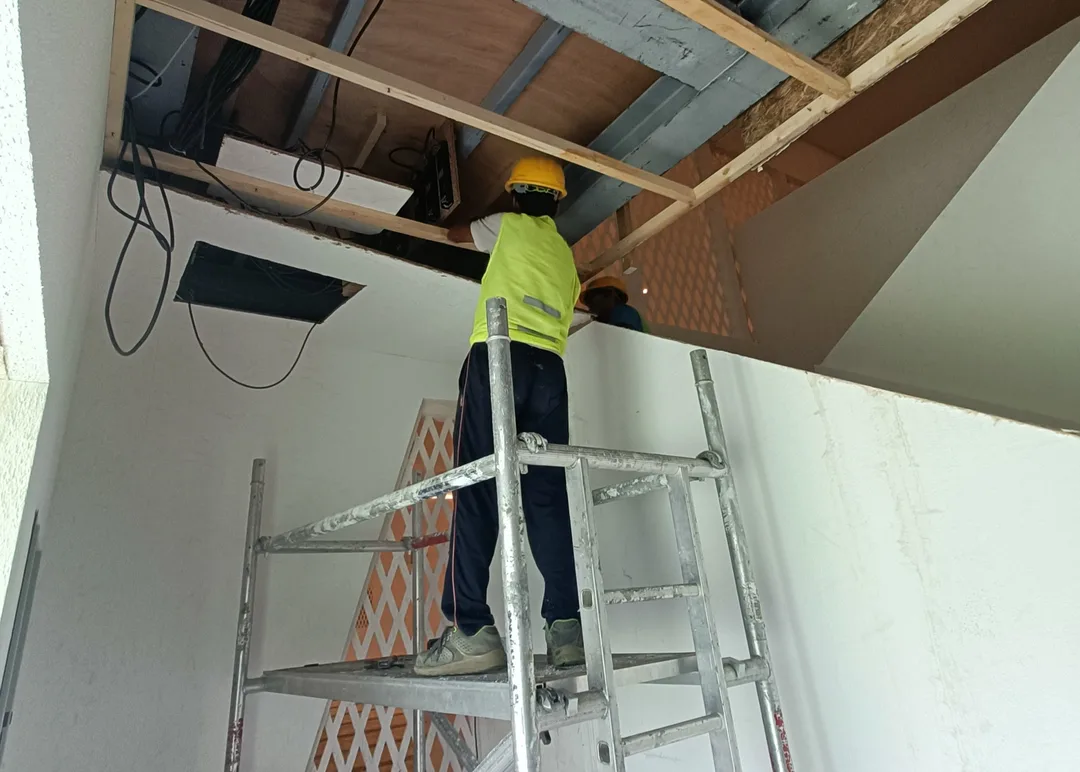 Finished permanent scenic wall shown beside its concealed structural and technical infrastructure.

