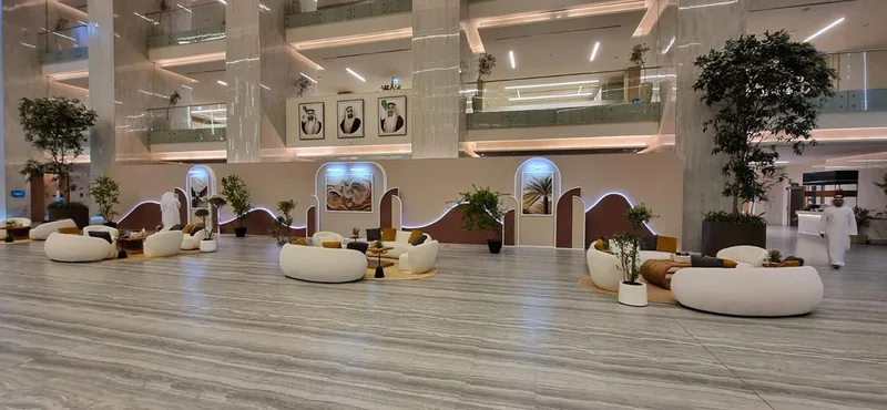 Three-metre gallery walling with wallpaper finishes and illuminated curved architectural details.