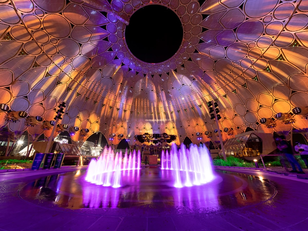 Image Illuminated scenic ring surrounding the operational rain curtain above the central stage.description