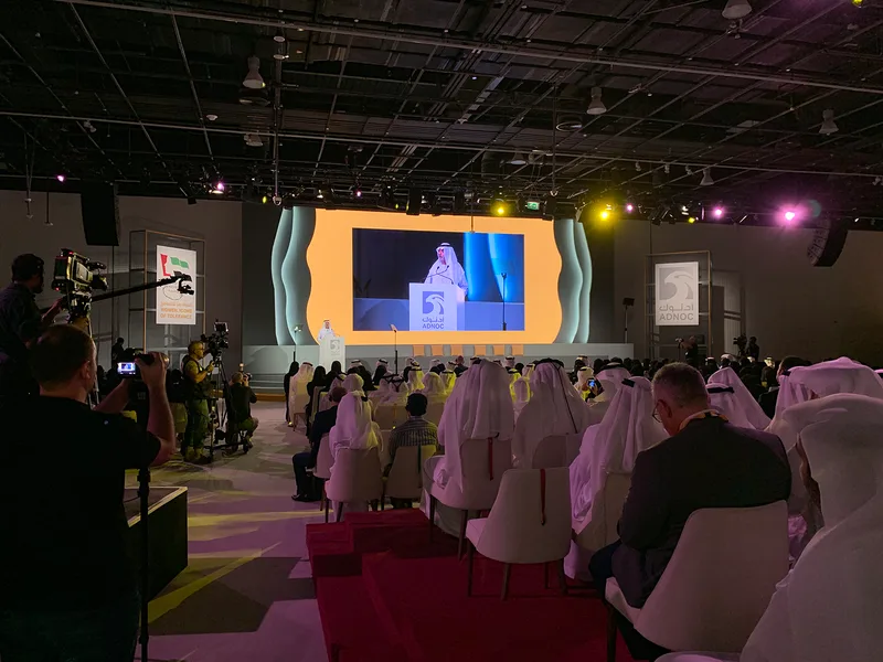 Illuminated stage-side features integrated into the wide presentation backdrop.