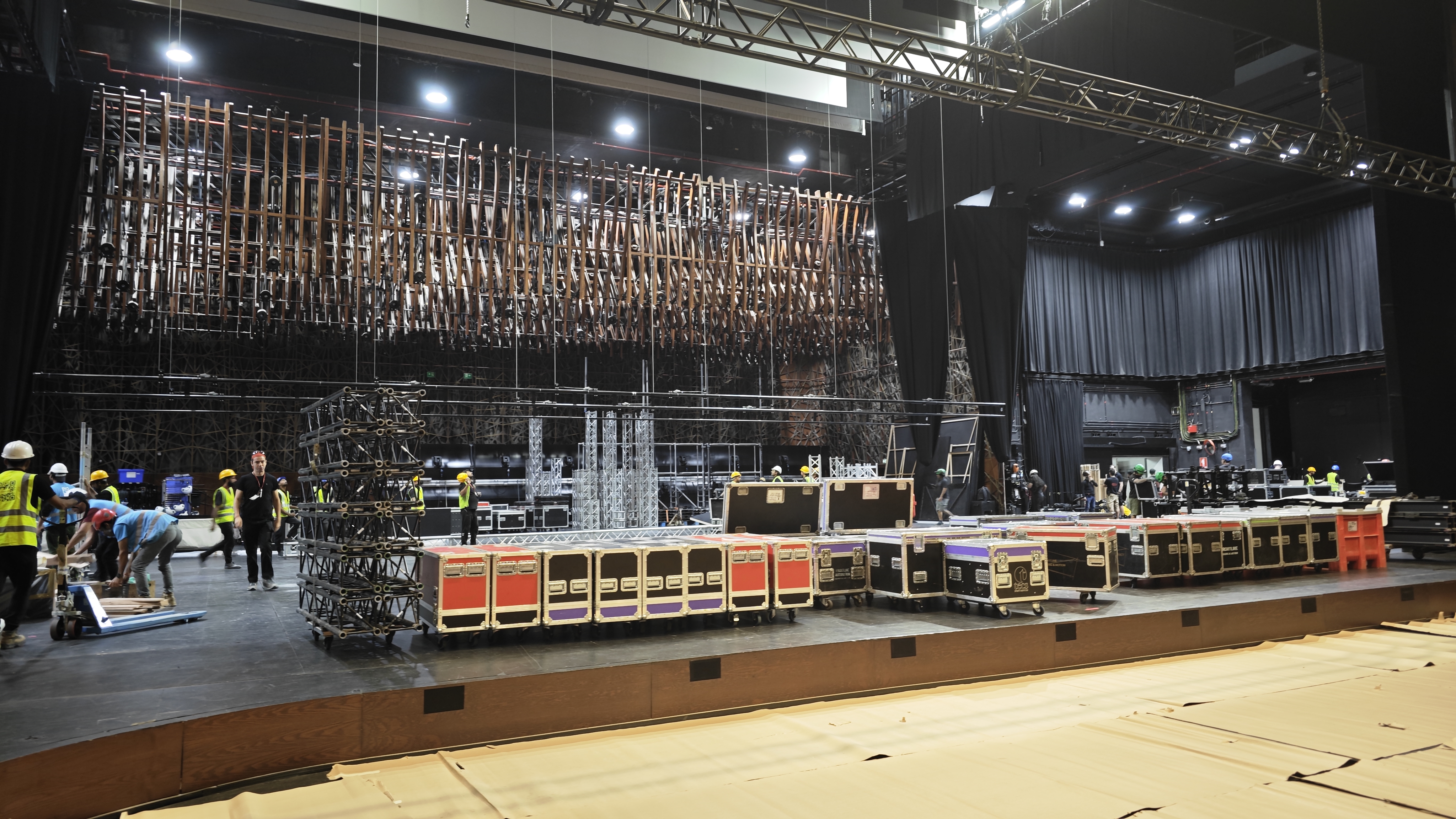 Black scenic drape concealing cables unfinished walls and operational areas
