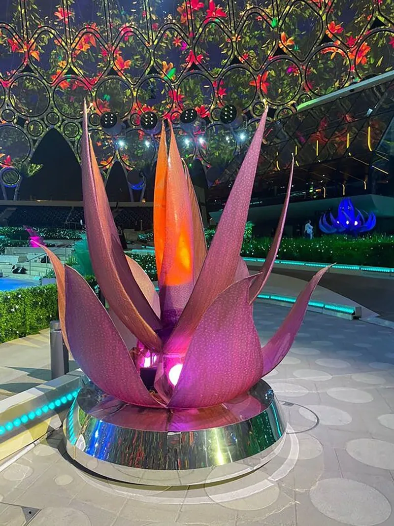 Illuminated scenic flower with layered fabric petals and integrated fibre-optic lighting.