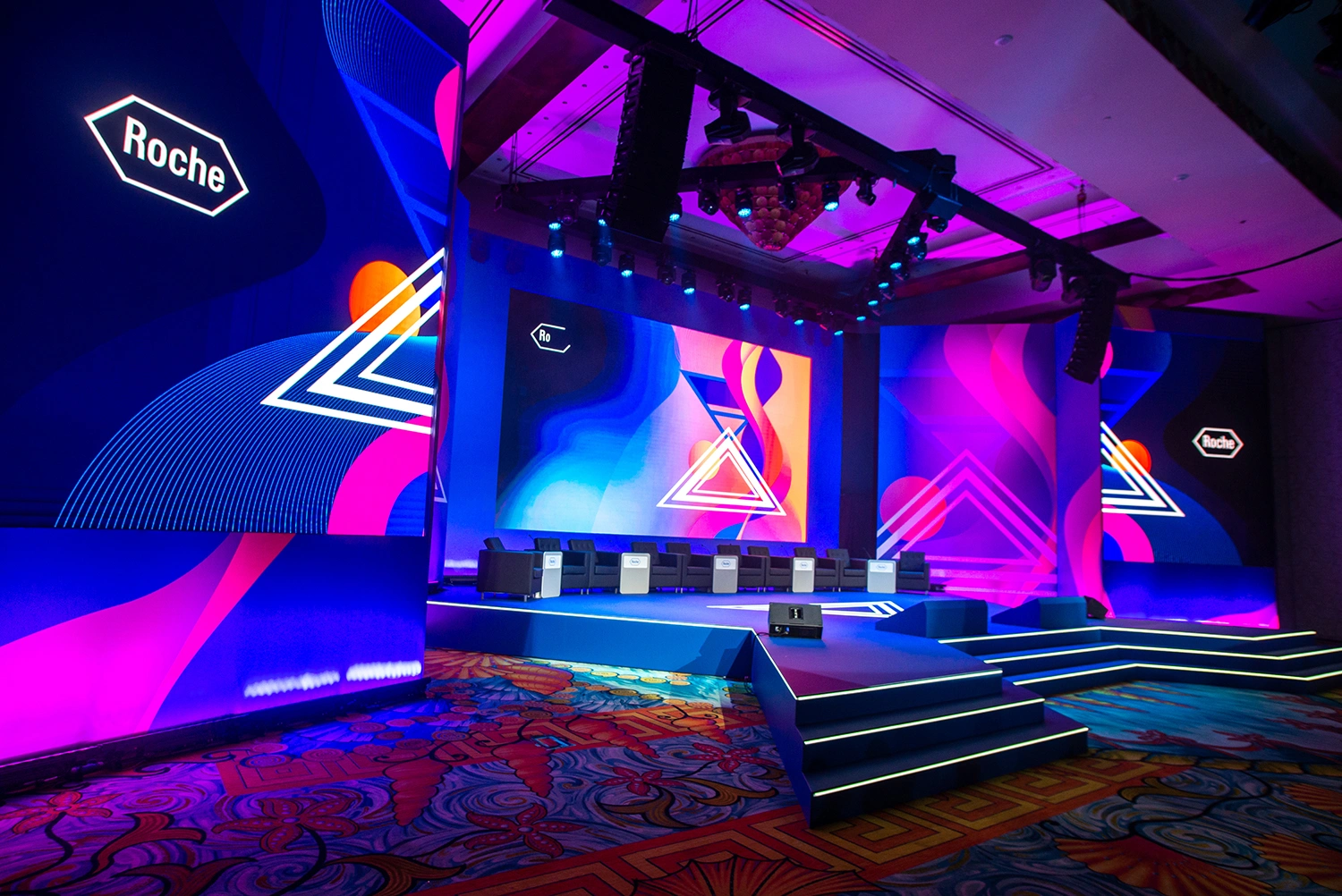 Evolution Scenic Roche conference stage with integrated LED screen surrounds in Dubai.