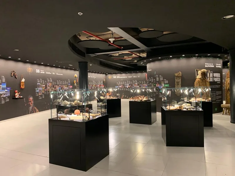 Custom exhibition flooring and skirting connecting black and white gallery environments.