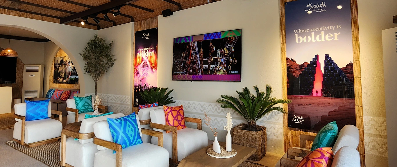 Evolution Scenic Visit Saudi tent with branded entrance, barasti ceiling and custom hospitality fit-out.