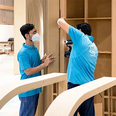 craftsman-installing-wooden-scenic-panels.webp