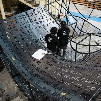 workers-assembling-metal-number-sculpture.webp