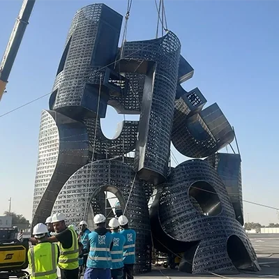crane-installing-large-metal-sculpture.webp