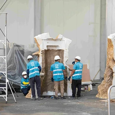 workers-assembling-large-white-scenic-structure.webp