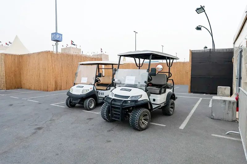 Golf buggies parked within an event operations area