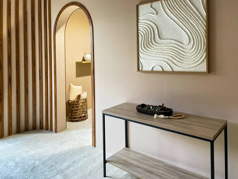 Contemporary interior fit-out with timber detailing, console table and textured wall artwork.