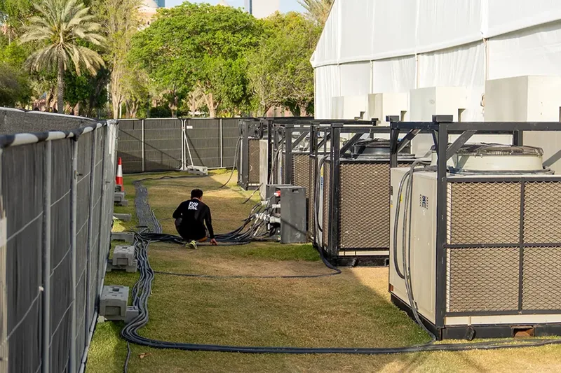 Temporary power units installed behind event site fencing