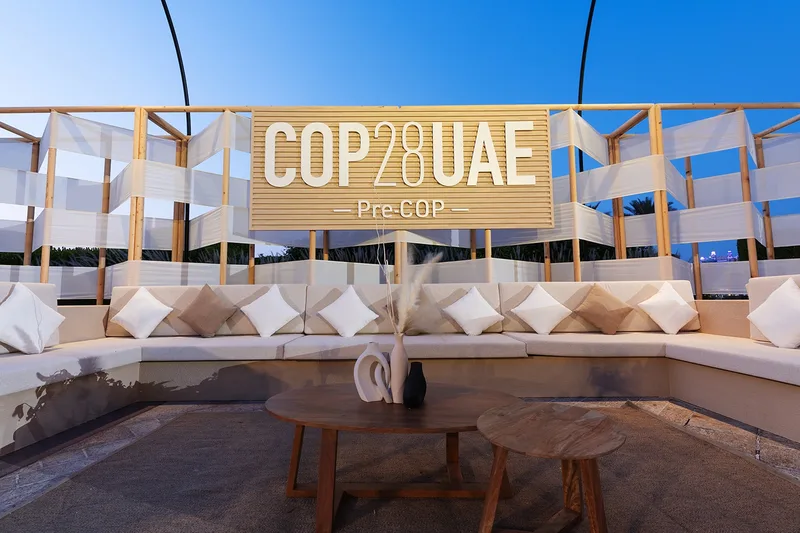 COP28 UAE outdoor pavilion with shaded seating and branded hospitality environment.