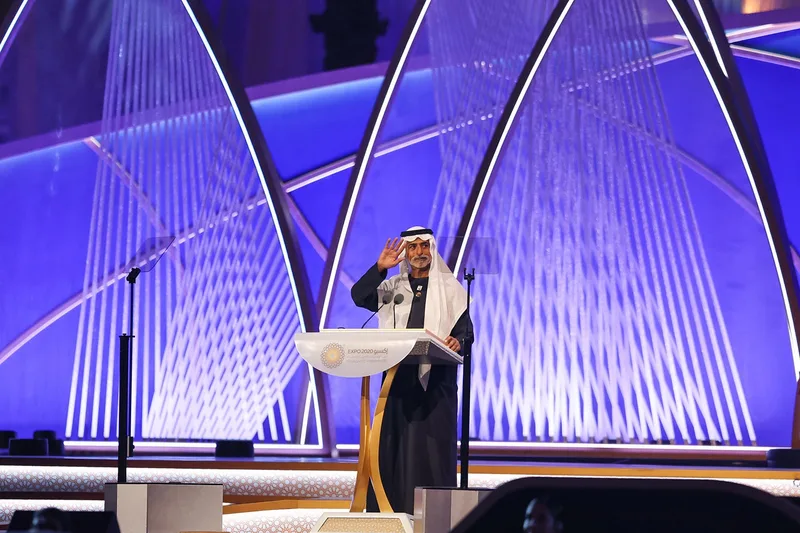 Speaker presenting on stage at a corporate event