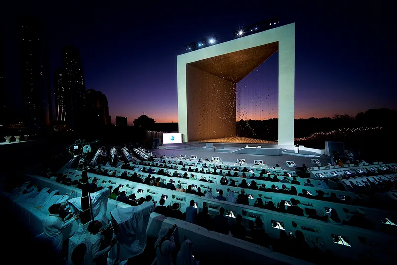 Outdoor event venue with large stage and audience seating