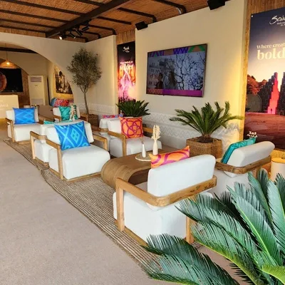 Colourful hospitality lounge with premium event furniture, plants and decorative styling.