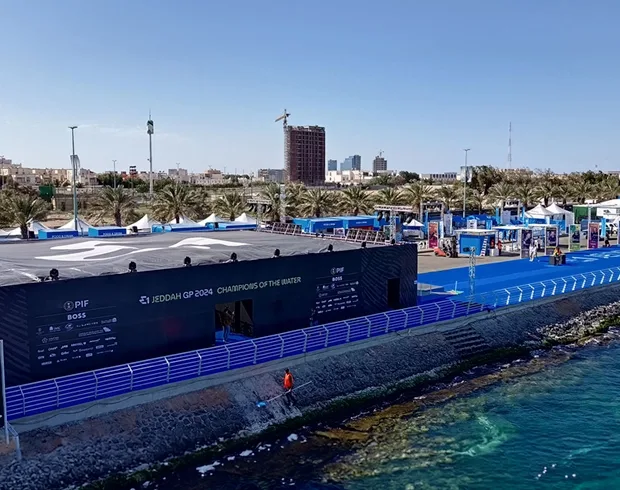 Waterfront sporting event environment with temporary seating, barriers and operational infrastructure.